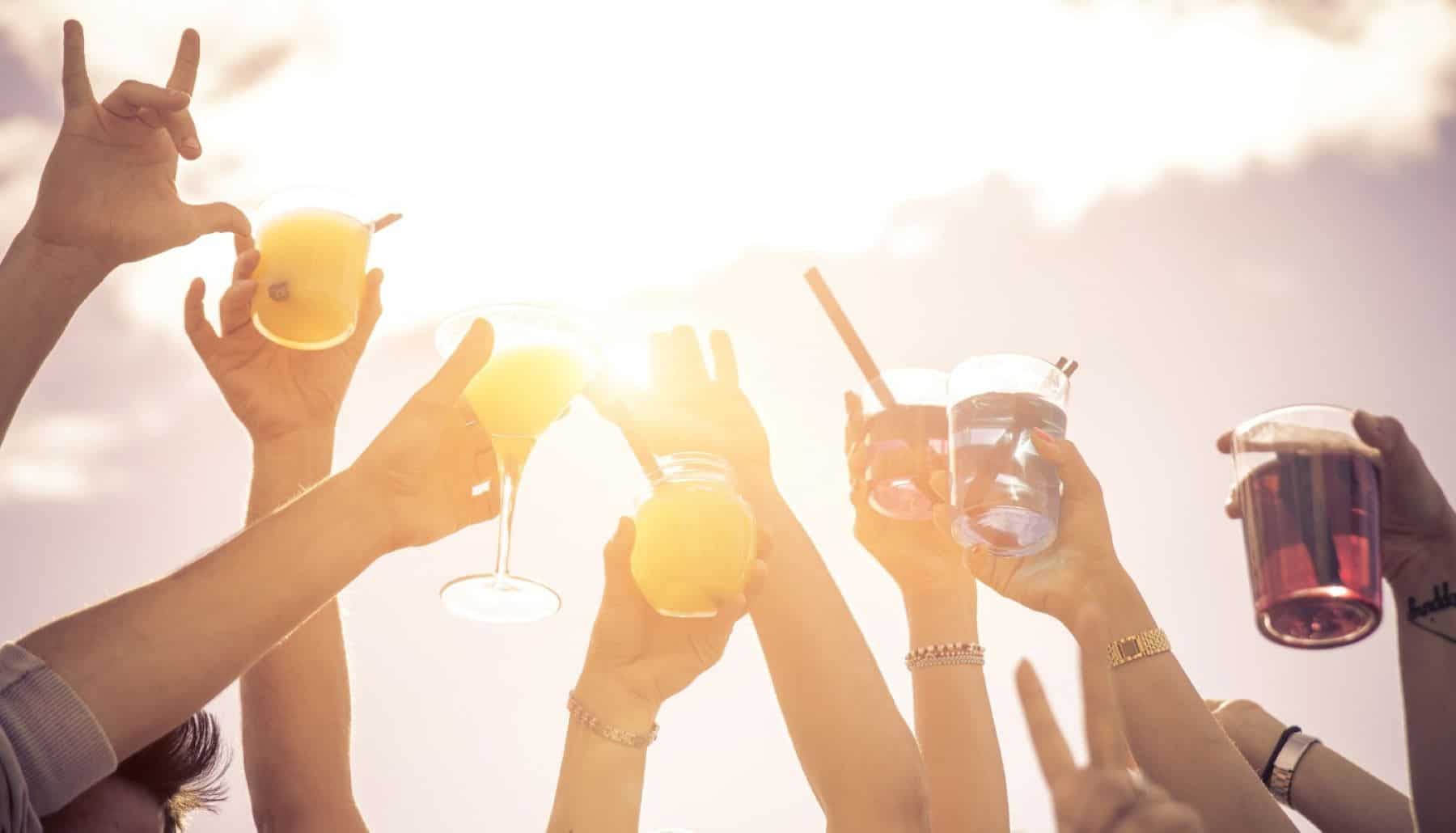 people raising glasses in the air